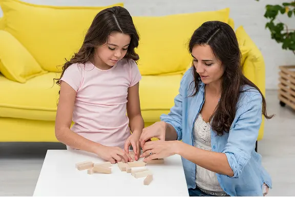 A parent and child sitting together at home